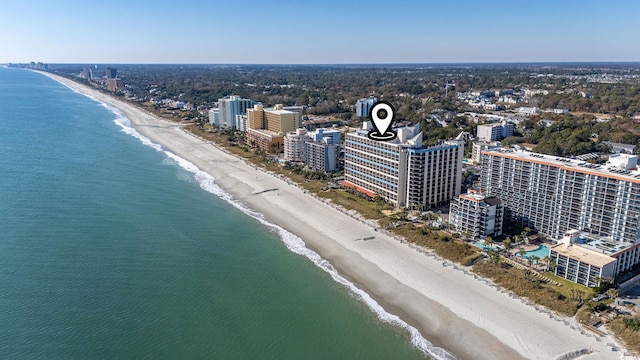 drone / aerial view featuring a water view and a beach view