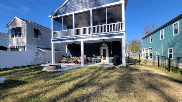 back of house featuring a fire pit, ceiling fan, a patio area, and a yard