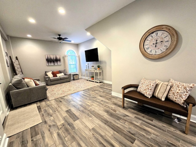 living room with hardwood / wood-style floors and ceiling fan