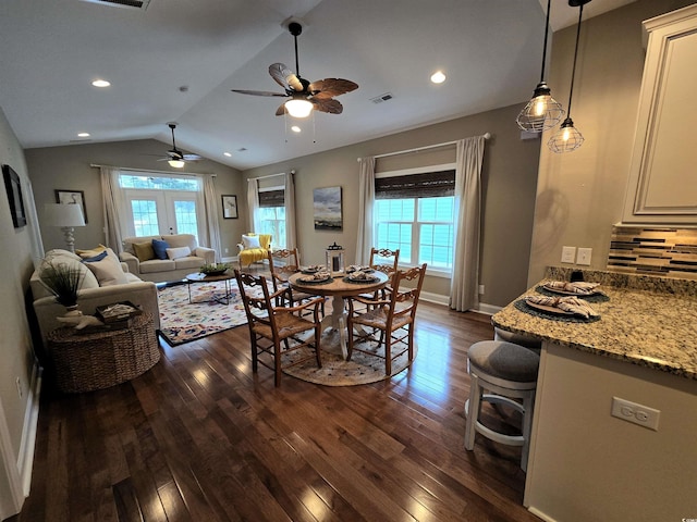 dining space with french doors, lofted ceiling, ceiling fan, and dark wood-type flooring