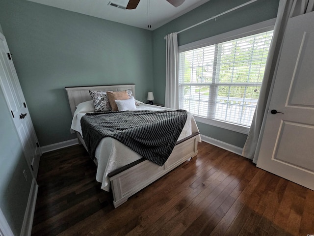 bedroom with ceiling fan and dark wood-type flooring