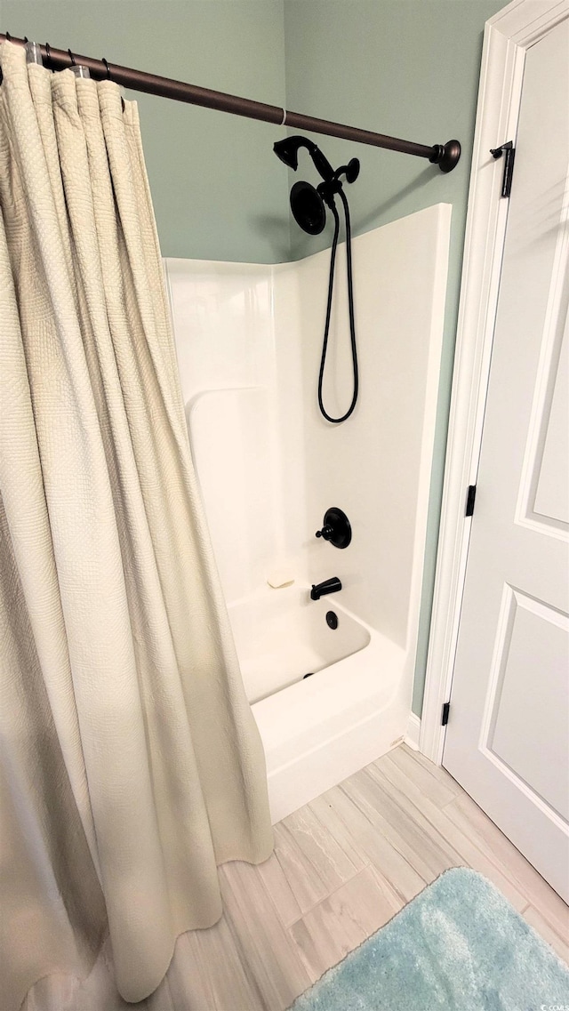 bathroom featuring shower / bath combination with curtain and wood-type flooring