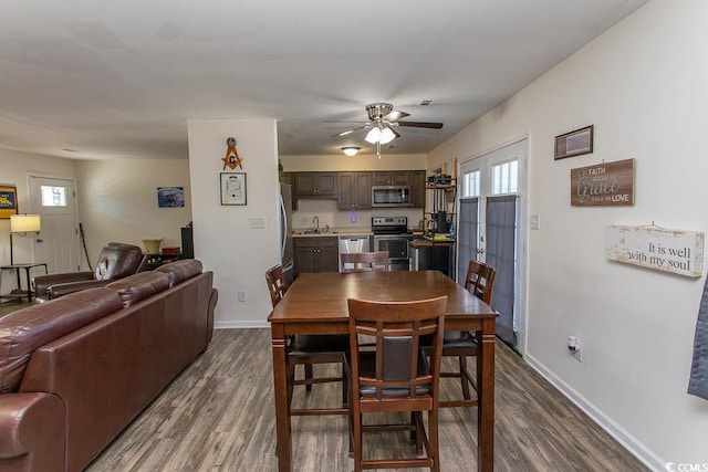 dining area featuring ceiling fan and dark wood-type flooring