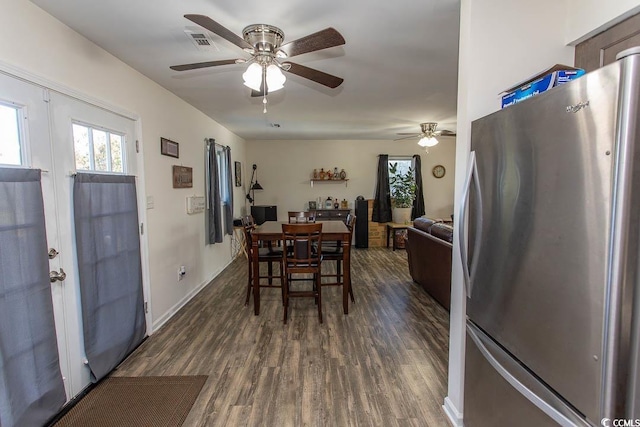 dining area with ceiling fan and dark wood-type flooring