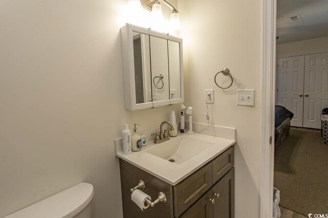 bathroom featuring vanity and toilet