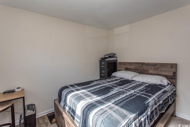 bedroom with hardwood / wood-style floors