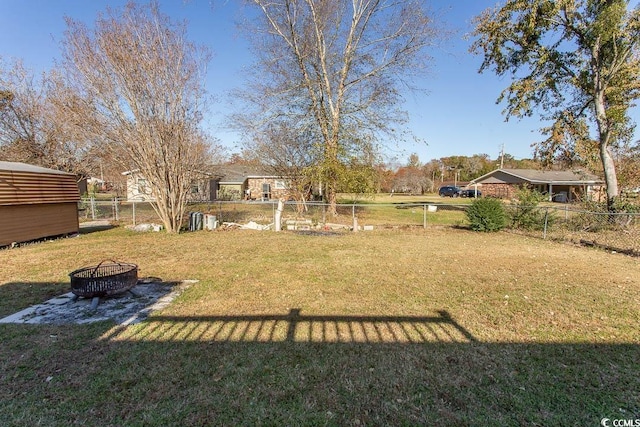 view of yard with an outdoor fire pit