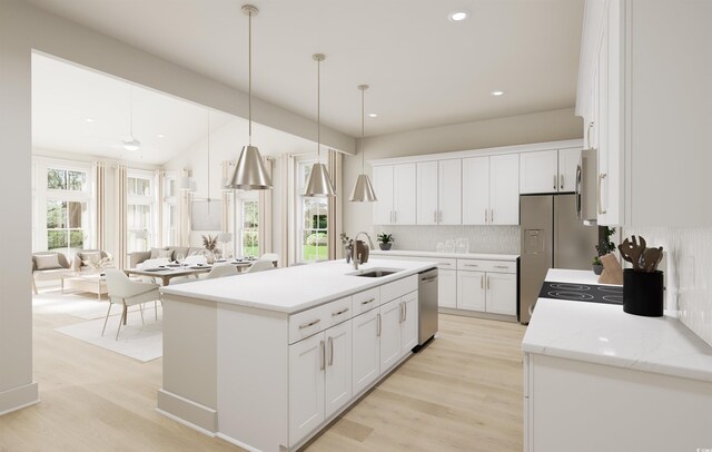 kitchen featuring pendant lighting, sink, a breakfast bar, stainless steel appliances, and an island with sink