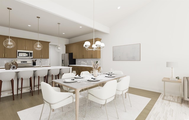 dining space with hardwood / wood-style floors and beam ceiling