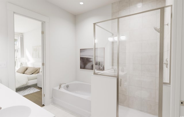 bathroom featuring sink and shower with separate bathtub