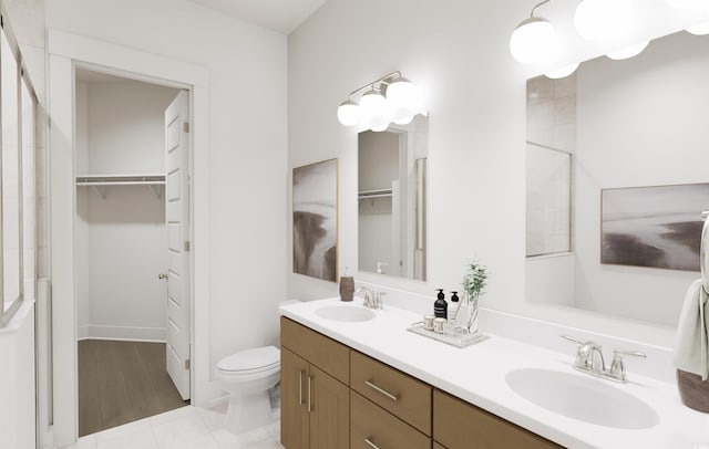 bathroom featuring tile patterned floors, toilet, vanity, and an enclosed shower