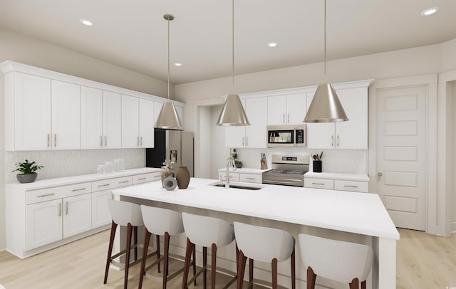 kitchen with a kitchen island with sink, sink, stainless steel appliances, and hanging light fixtures