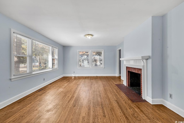 unfurnished living room with a fireplace and wood-type flooring