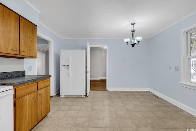 kitchen featuring white appliances, crown molding, hanging light fixtures, and a chandelier