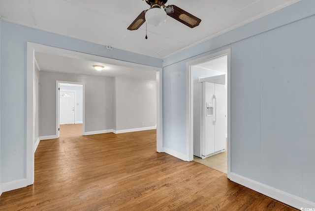 empty room featuring ceiling fan and light wood-type flooring