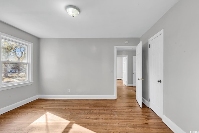 empty room with hardwood / wood-style flooring