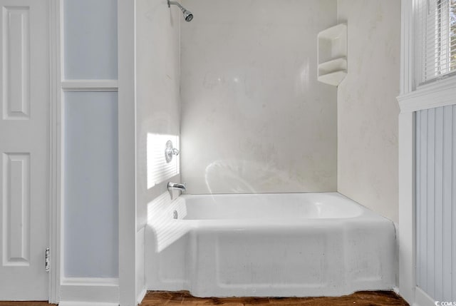 bathroom with hardwood / wood-style floors and  shower combination