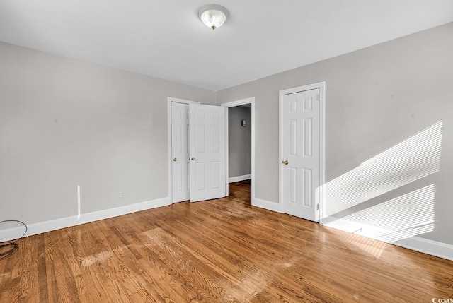 unfurnished bedroom with hardwood / wood-style floors