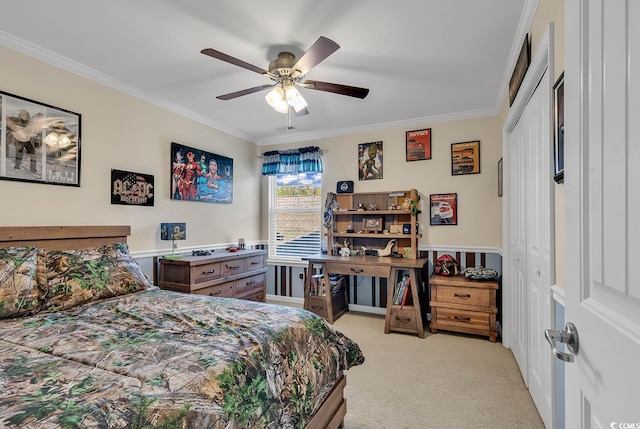 bedroom with ceiling fan, light colored carpet, crown molding, and a closet