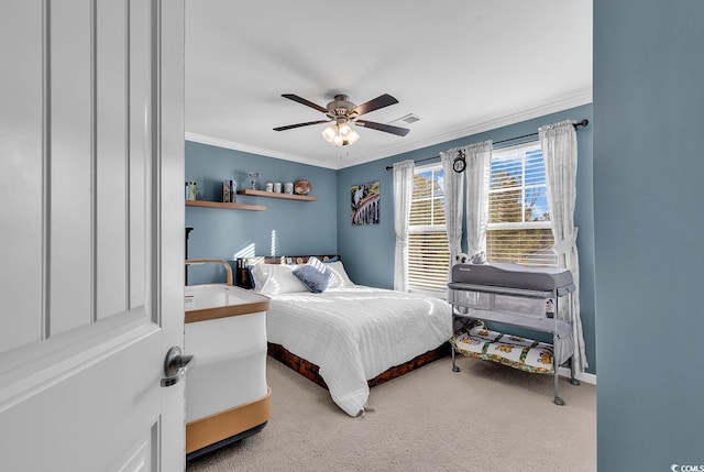 carpeted bedroom featuring ceiling fan and ornamental molding