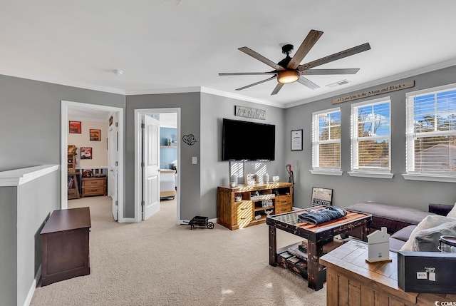 carpeted living room featuring ceiling fan and ornamental molding