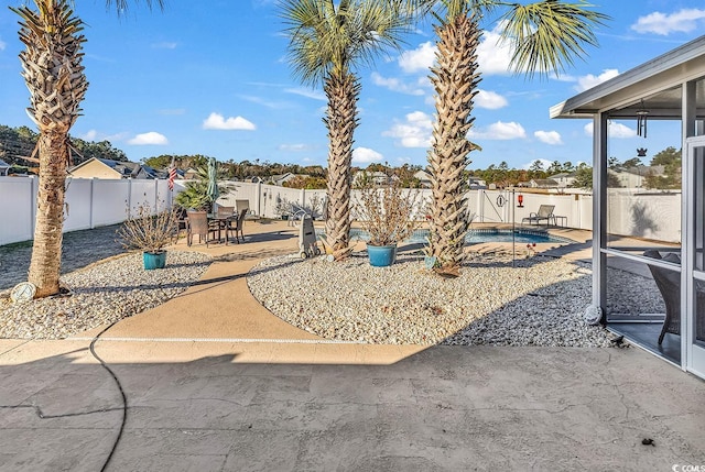 view of yard with a fenced in pool and a patio