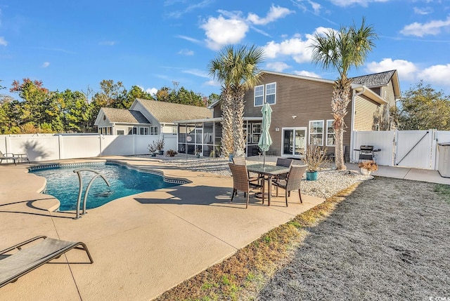 view of swimming pool with a patio area, a grill, and a sunroom