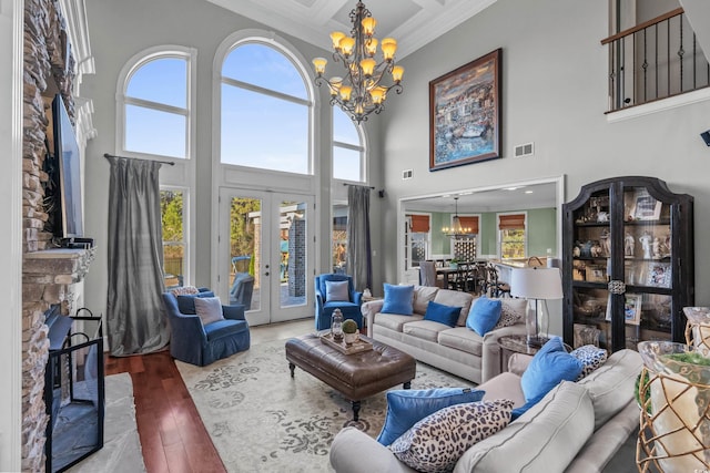 living room featuring french doors, a towering ceiling, and a wealth of natural light