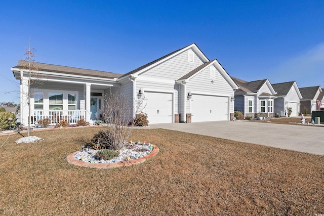 ranch-style house featuring covered porch, a garage, and a front yard