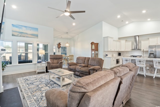 living room with ceiling fan, dark hardwood / wood-style flooring, and high vaulted ceiling