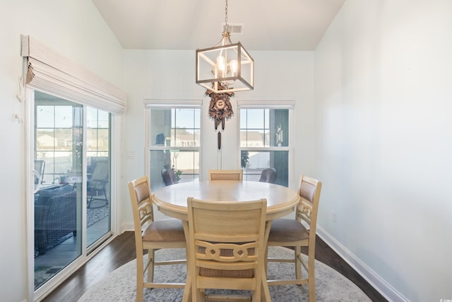 dining room featuring a chandelier, dark hardwood / wood-style flooring, and a healthy amount of sunlight