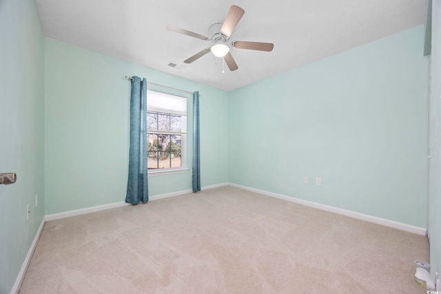 empty room featuring light colored carpet and ceiling fan