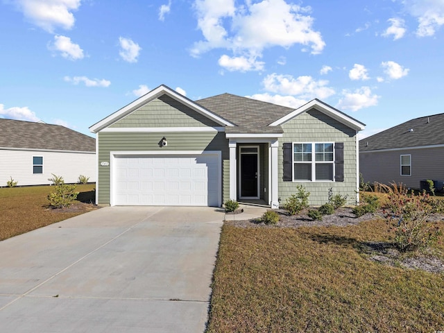 view of front of property featuring a garage and a front lawn