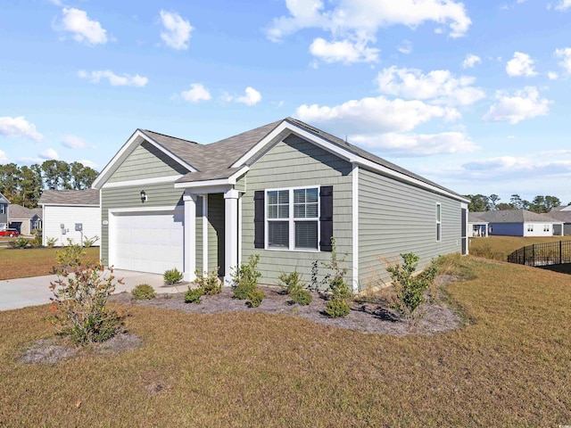 view of front of house with a front yard and a garage