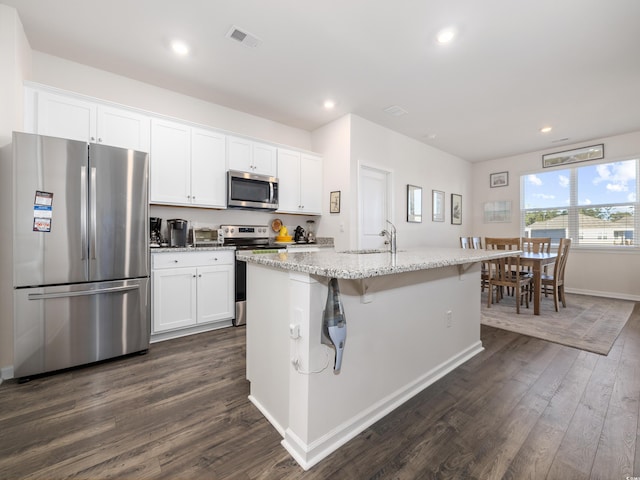 1143 Sennema Cir, Myrtle Beach, SC 29588 - kitchen featuring appliances with stainless steel finishes, dark wood-type flooring, white cabinets, a kitchen island with sink, and recessed lighting