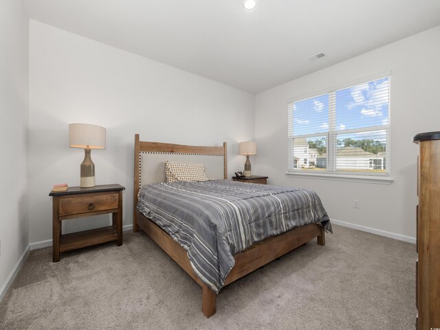 bedroom with light colored carpet