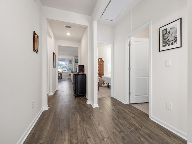 hallway with dark hardwood / wood-style floors