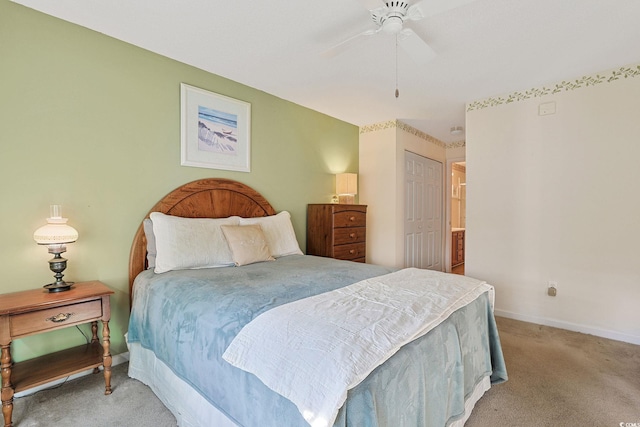 carpeted bedroom with ceiling fan and a closet