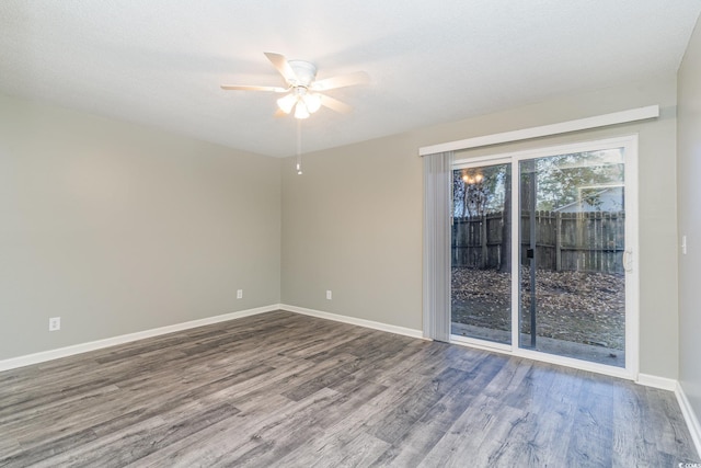 empty room with ceiling fan, wood-type flooring, and a textured ceiling