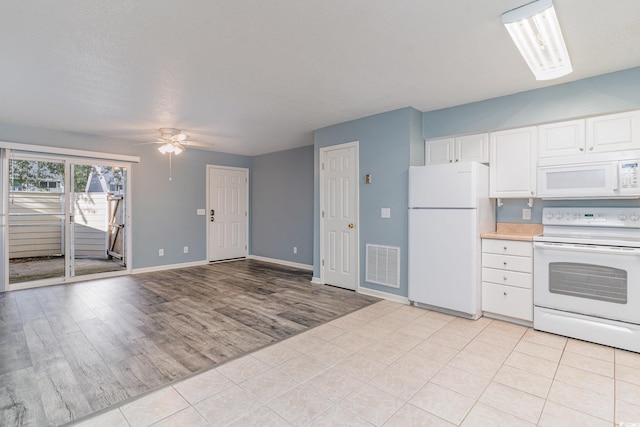 kitchen featuring a textured ceiling, white appliances, ceiling fan, light hardwood / wood-style flooring, and white cabinets