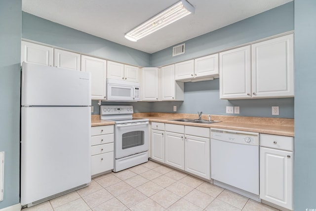 kitchen with white cabinetry, white appliances, sink, and light tile patterned floors