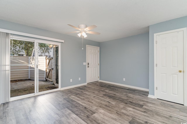 unfurnished room featuring ceiling fan and hardwood / wood-style flooring