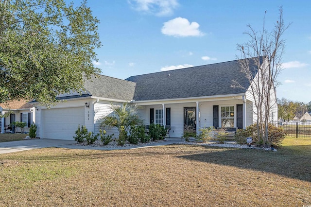 view of front of house featuring a porch, a front yard, and a garage