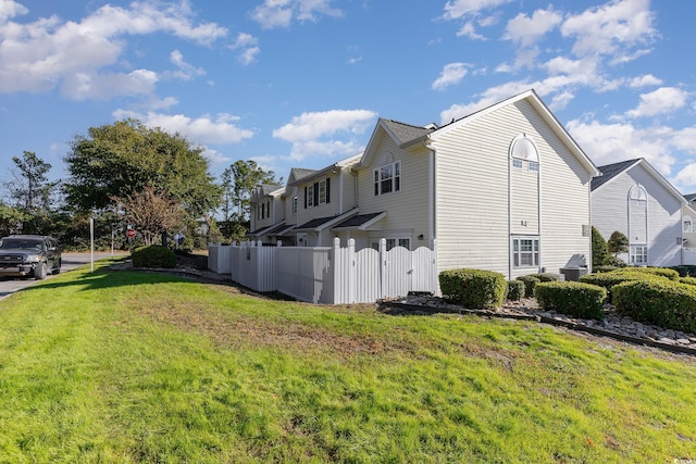 view of property exterior with a yard