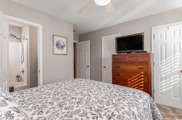 carpeted bedroom with ceiling fan and a textured ceiling