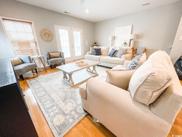 living room with light hardwood / wood-style floors and french doors