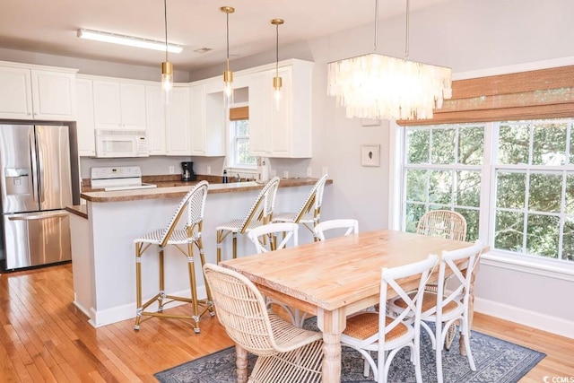 dining space featuring a chandelier and light hardwood / wood-style floors