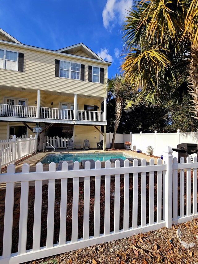 view of front of home featuring a fenced in pool