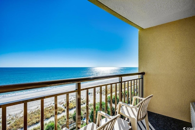 balcony with a view of the beach and a water view