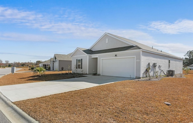 view of front of house with a garage and central air condition unit